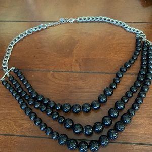 Black beaded multi-strand necklace with silver colored hardware